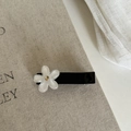 Close-up of duckbill hair clip with white frosted flower and golden rhinestone detail - Cream White Flower Black Duckbill Clip