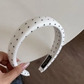 Detail of white sponge headband with black heart pattern and stitched brand label - White Headband (Black Heart) (3CM)