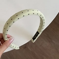 Detail of light green fabric headband featuring small black heart prints and inner label - Green Headband (Black Heart) (2CM)