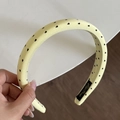 Detail of light yellow satin headband with black heart pattern held by hand - Yellow Headband (Black Heart) (2CM)