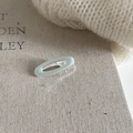 Macro detail of oval mint green enamel hair clip on a textured fabric background - Green Oval Duckbill Clip