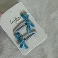 Detail of teal velvet bows on silver glitter hair clips pinned to product display card - Silver Water Drop Hair Clip Bow Style