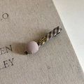 Detail of vintage plaid hair clip with a mauve fabric ball and gold lettering - Milky Tea Black Plaid Duckbill Clip With Pink Ball