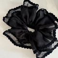 Detail view of large black double-layer lace scrunchie with scalloped velvet trim - Black