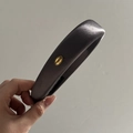 Detailed view of handmade dark grey satin headband with gold Korea metal label - Gray