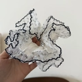 Detail of white mesh hair scrunchie with black floral print and contrast wavy trim edge - Black Edge White