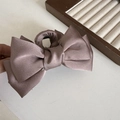 Detailed close-up of a pink satin multi-layer bow hair claw with fabric wrapping - Coffee