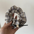 Beige plaid scrunchie with a black bow and wooden button detail for hair styling - White Blue Striped Scrunchie Bow