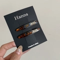 Detail of two tortoise shell acetate hair clips on a black Hanns brand display card - Blue Tortoiseshell Willow Leaf Style