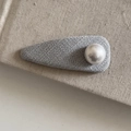 Elegant grey fabric hair clip with a large pearl detail on a textured beige surface - Grey Teardrop Hair Clip Single Artificial Pearl