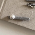 Macro view of grey tweed fabric hair clip with a white pearl on a linen background - Grey Long Strip Hair Clip Single Pearl