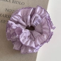 Close-up of lavender silk hair scrunchie with layered ruffles and purple stitched edges - Elegant Purple