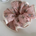 Detail view of pink floral chiffon hair scrunchie with delicate off-white stitched edges - Pink Floral Scrunchie