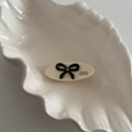 Close-up of an oval acetate hair clip with a black bow and France Handmade text - 7# White Oval With Black Bow
