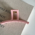 Macro view of a matte pink rectangle hair claw clip with golden metal spring on canvas book - 6# Pink Rectangular Hollow