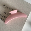 Close-up of a pink crescent hair claw clip on a texture book showing smooth glossy finish - 7# Pink Crescent Glossy