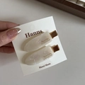 Detalle de pinzas para el cabello de acetato blanco perlado con base de metal dorado - Blanco Perla Iridiscente