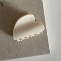 Close-up of a heart-shaped cream white hair claw clip with smooth finish and teeth detail - 20# Cream White Heart