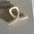 Detailed view of cream-colored resin shark hair claw clip with golden metal spring - 21# Milky White Cross Twist