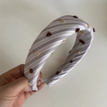 Detailed texture of striped lace fabric hair tie with decorative fuzzy pom-poms - Coffee Striped Style