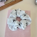 Detail view of light blue lace scrunchie featuring elegant black bow embroidery patterns - Blue Basic Black Bow