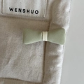 Detailed macro view of the sage green fabric bow hair clip with fine twill texture - Hair Bow / Green