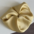 Detail showing the champagne gold satin scrunchie with silky texture and elegant folds - 10# Solid Yellow Scrunchie