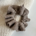 Macro shot of coffee brown knit scrunchie with soft wavy texture and ribbed fabric detail - Coffee
