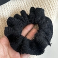 Detailed view of black knitted scrunchie showing mohair texture and crochet pattern - Black