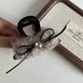 Detail of plush bow hair claw clip with crystal rhinestone and soft velvet lining - Khaki Plush Black Claw