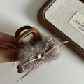 Detail of plush grey hair claw clip featuring a gold metal bow and crystal gemstone - Khaki Plush Caramel Claw