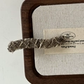 Detailed macro view of French wool-wrapped hair clip with vintage knitting texture - Khaki Wavy Long Bar Style