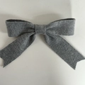 Detailed view of gray knitted ribbon bow hair clip with vertical ribbed texture and spring clip - Light Gray