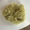 Close-up texture of a soft mustard green plush oversized scrunchie for winter hair styling - Green Plush