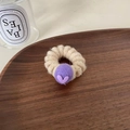 Beige knit hair tie featuring a purple pompom and heart charm on a wooden tray - White Hair Tie With Purple Heart