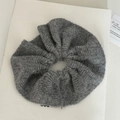 Close-up of soft grey mohair scrunchie showing the fluffy knitted wool texture - Gray