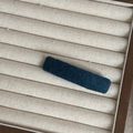 Minimalist rectangular hair clip with dark blue felt fabric texture on beige display tray - Blue Rectangular Clip