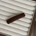 Close-up of a dark brown plush fabric BB hair clip on a minimalist white display tray - Khaki Rectangular Clip