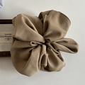 Close-up detail of oversized khaki scrunchie showing pleated texture and woven fabric - Coffee