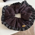 Dettaglio di scrunchie a quadri rossi e neri con bordi arricciati e placchetta dorata - Volant Gingham Rosso e Nero