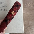 Dettaglio cerchietto scozzese rosso con emblema dorato di carattere cinese della fortuna - Fascia Tartan Rossa (Ricchezza)