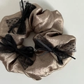 Elegant bronze metallic satin scrunchie with black lace bow accents on white background - Khaki With Black Bow