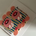 Close-up of pink acrylic bunny hair clips with striped details on a display card - Yellow Blue Striped Rabbit Pair