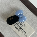 Detail of a handmade blue acetate bow hair clip with gold France engraving - Blue Bow Black Hair Clip