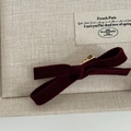 Close-up of deep red velvet bow hair clip with gold metal alligator fastener detail - Red Flocked Bow Hair Clip