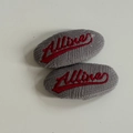 Detail of grey corduroy hair clip featuring red Allure cursive embroidery on white background - Gray Embroidered Style / Hair Clip