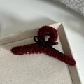 Close-up of wine red fuzzy faux fur hair claw clip with a black leather bow detail - Large / Burgundy