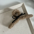 Detail view of large brown tweed hair claw clip with black leather bow accent - Large / Coffee