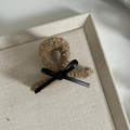 Detail of khaki plush hair claw clip with black leather bow and gold thread accents - Small / Coffee