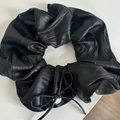 Detailed view of large black faux leather scrunchie with bow tie and silver metal tag - Black Bow Scrunchie #6